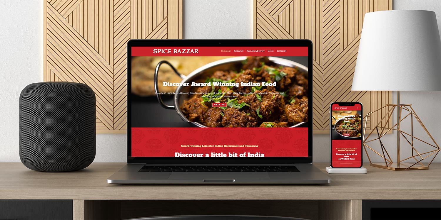 A laptop and smartphone showing  the web design for Leicester-based client Spice Bizzar