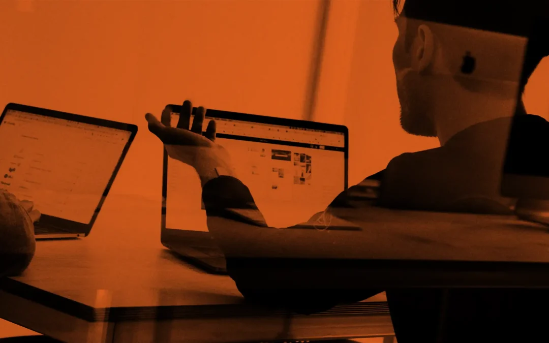 Two people sat at laptops